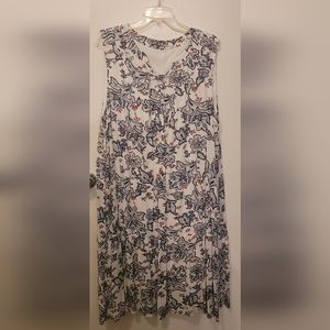 Sleeveless white dress with blue and red design.